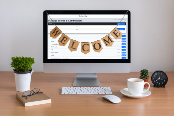 A desk set up with a welcome banner across the screen
